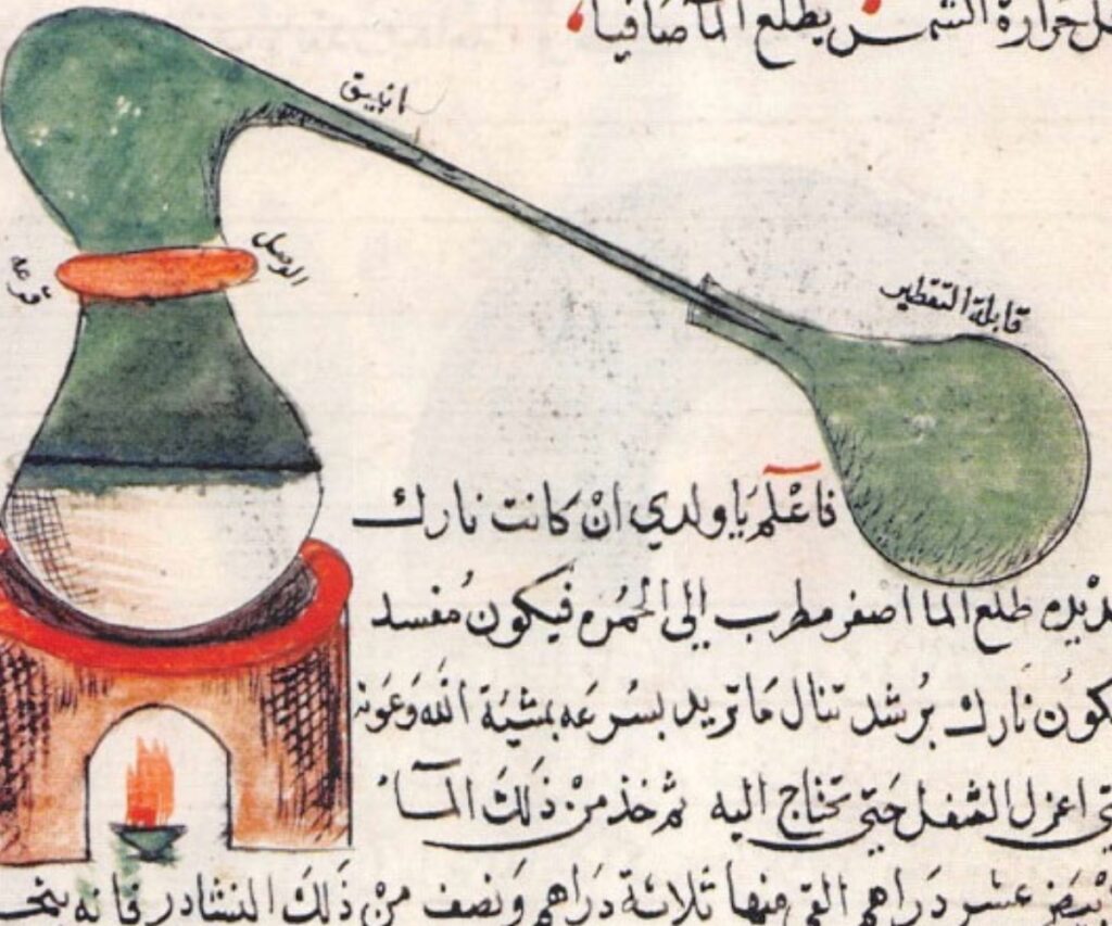 The image depicts an illustration of an alembic, a distillation apparatus, accompanied by Arabic text. The apparatus features a flask with a curved tube leading to a receiving vessel, and it is placed over a heat source. The handwritten text appears to describe the distillation process, likely from a historical manuscript related to early chemistry or alchemy, attributed to Jabir Ibn Hayyan.