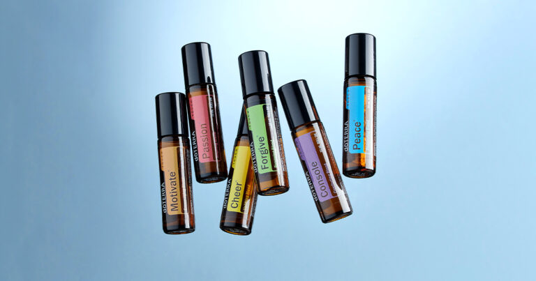 Six essential oil roller bottles from doTERRA labeled with different emotional support blends: Motivate, Passion, Cheer, Forgive, Console, and Peace, arranged against a light blue background.