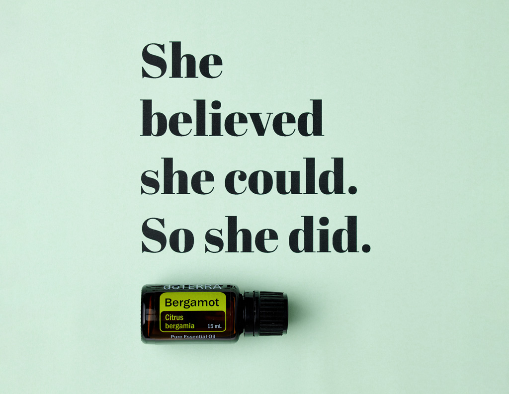 The image shows a bottle of doTERRA Bergamot essential oil placed below a bold, inspirational quote that reads, “She believed she could. So she did.” The minimalist design on a light green background emphasizes the uplifting message, pairing it with the calming, citrus essence of bergamot oil.